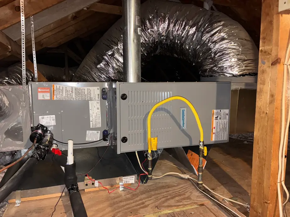 Attic air handler beside a Comfortmaker gas furnace with flex duct and a new gas line